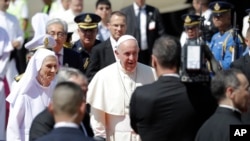 Pope Francis walks with his cousin Ana Rosa Sivori as he arrives at Military Air Terminal of Don Muang Airport, Wednesday, Nov. 20, 2019, in Bangkok, Thailand.