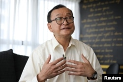 FILE - Self-exiled Cambodian opposition party founder Sam Rainsy speaks during an interview with Reuters at a hotel in Kuala Lumpur, Malaysia, Nov. 10, 2019. REUTERS/Lim Huey Teng