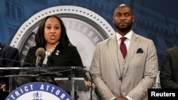 FILE - Fulton County District Attorney Fani Willis speaks at a press conference next to prosecutor Nathan Wade in Atlanta, Georgia, Aug. 14, 2023. Wade withdrew from the Donald Trump election interference case on March 15, 2024, after a judge ruled either he or Willis must go.