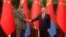 Chinese Premier Li Qiang, right, and Eritrean President Isaias Afwerki shake hands as they attend a meeting at the Great Hall of the People in Beijing, May 15, 2023. 