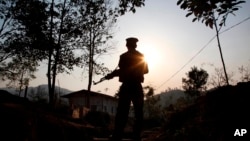 FILE- A Kachin Independence Army rebel stands at an outpost in Lawa Yang, Myanmar, March 20, 2018. Witnesses reported on Nov. 26, 2024, that the KIA took control of a key trading town on the Chinese border and a rare earth mining hub.