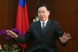 FILE - Taiwanese Foreign Minister Joseph Wu gestures while speaking during an exclusive interview with The Associated Press at his ministry in Taipei, Taiwan, Dec. 10, 2019.