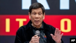 Former President of the Philippines Rodrigo Duterte speaks inside the Southorn Stadium during a thanksgiving gathering organized by Hong Kong-based Filipino workers for the former populist president in Hong Kong on March 9, 2025.