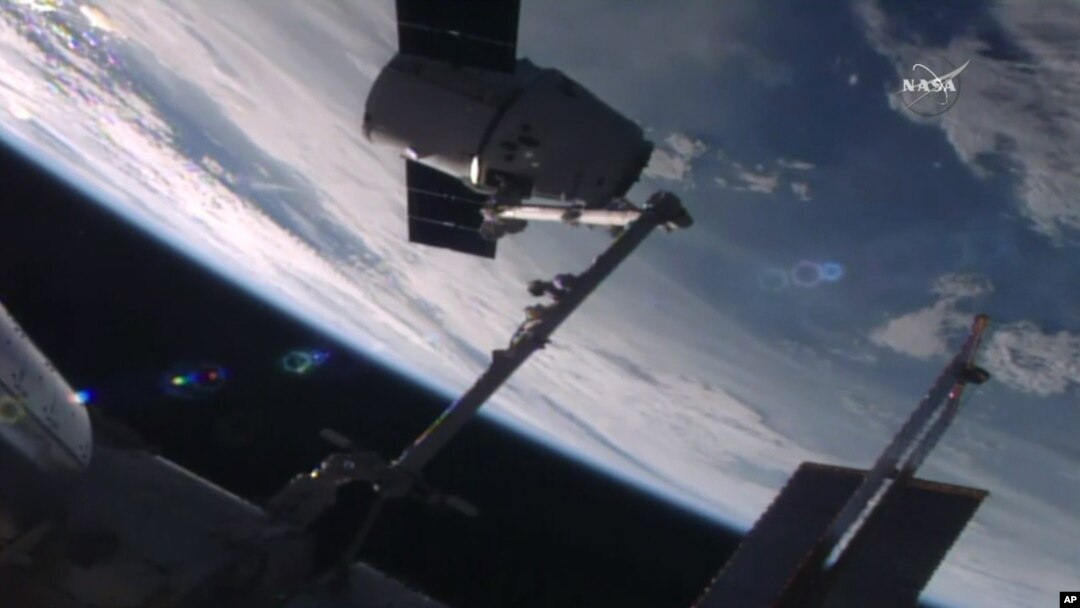 In this frame from NASA TV, the SpaceX Dragon capsule arrives at the International Space Station bearing supplies on July 20, 2016. 