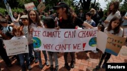 Young environmental activists hold banners as they demonstrate, calling for action on climate change during the "Fridays for Future" school strike, in Istanbul, Turkey, May 24, 2019.