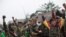 Members of community based anti-narcotic campaigners known as The Pat Jasan shout slogans protesting against the government’s ban prohibiting the group from destroying poppy farms in Wai Maw, northern Kachin State, Myanmar, Feb. 21, 2016.