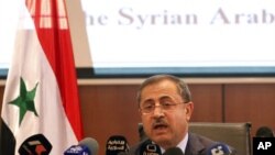 Syria's Interior Minister Mohammed al-Shaar announces the results of the referendum on a new constitution in Damascus, February 27, 2012.