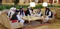 FILE - Members of the Taliban delegation are seen at the Sheraton Doha, before the start of the intra-Afghan dialogue, in Doha, Qatar, July 7, 2019.