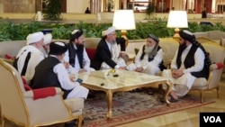 FILE - Members of the Taliban delegation are seen at the Sheraton Doha, before the start of the intra-Afghan dialogue, in Doha, Qatar, July 7, 2019.