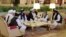 FILE - Members of the Taliban delegation are seen at the Sheraton Doha, before the start of the intra-Afghan dialogue, in Doha, Qatar, July 7, 2019.