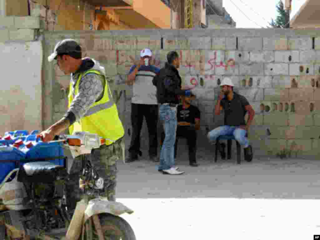 Some refugees have jobs with the construction companies rebuilding the camp. Workers say the pay is low, and often late.