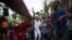 Yensy Villarreal, 9, (C), who lives in Miami, dances in the backyard of his home with friends in celebration for becoming a Santero after passing a year-long rite of passage in the Afro-Cuban religion Santeria, Havana, July 5, 2015.