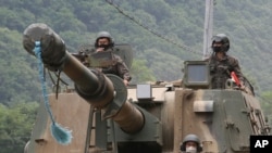 South Korean army soldiers ride a K-9 self-propelled howitzer during the annual exercise in Paju, South Korea, near the border with North Korea, June 23, 2020.