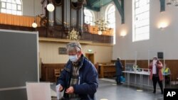People vote in general elections in a church in the village of Ransdorp, near Amsterdam, Netherlands, March 17, 2021.