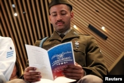 Private First Class Diaz Salazar waits to take his Oath of Allegiance during his U.S. Citizenship and Immigration Services naturalization ceremony at the New York Public Library in New York on July 2, 2024.