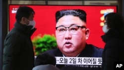 People walk by a TV screen showing North Korean leader Kim Jong Un during a ruling party congress, at the Seoul Railway Station in Seoul, South Korea, Wednesday, Jan. 6, 2021. Kim opened his country's first ruling party congress in five years with…