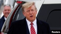 FILE - Former U.S. President and Republican presidential candidate Donald Trump reacts after arriving at Aberdeen International Airport in Aberdeen, Scotland, Britain May 1, 2023.