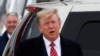 FILE - Former U.S. President and Republican presidential candidate Donald Trump reacts after arriving at Aberdeen International Airport in Aberdeen, Scotland, Britain, May 1, 2023.