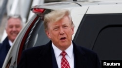 FILE - Former U.S. President and Republican presidential candidate Donald Trump reacts after arriving at Aberdeen International Airport in Aberdeen, Scotland, Britain, May 1, 2023.