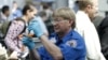 A TSA agent looks over a license at a security check point.