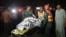 Pakistani rescuers use a stretcher to shift a body from a bomb blast site in Lahore on March 27, 2016. 