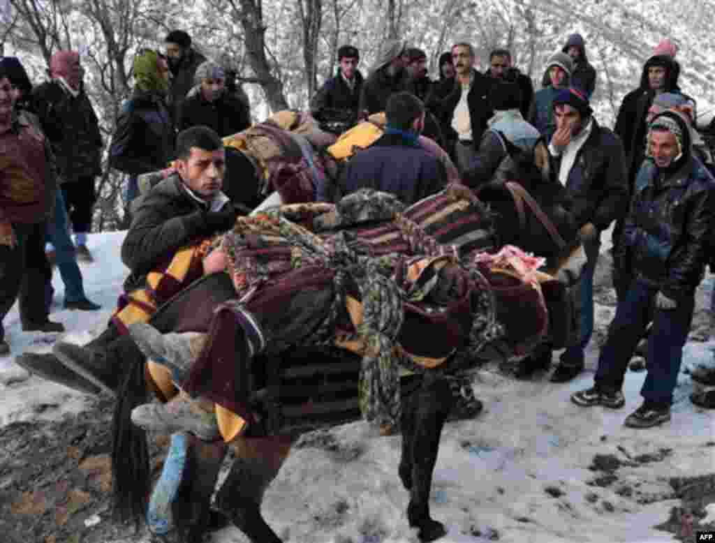 People mount bodies onto mules after Turkey's air force attacked suspected Kurdish rebel targets across the border in Iraq, killing at least 35 people, many of them believed to be smugglers mistaken for guerrillas, near the Turkish village of Ortasu in Si