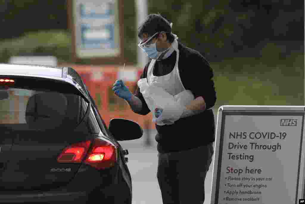 El conductor de un automóvil se hace la prueba para COVID-19 en el parque temático Chessington, en el suroeste de Londres, Reino Unido.