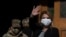 Bolivia's interim President Jeanine Anez, wearing a face mask to help curb the spread of the new coronavirus, waves during a procession Corpus Christi, in La Paz, Bolivia, June 11, 2020.