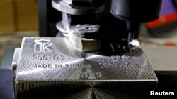 FILE PHOTO: A machine engraves information on an ingot of 99.97 percent pure palladium at a plant of Krastsvetmet