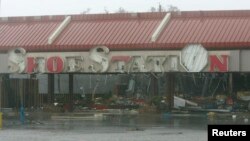 FILE - The Shoe Station, along with the majority of business in the Edgewater Village shopping Center, sustained extreme damage from Hurricane Katrina, Aug. 29, 2005. 