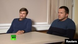 A still image taken from video footage and released by Russia's RT international news channel Sept. 13, 2018, shows two Russian men identified as Alexander Petrov and Ruslan Boshirov during an interview at an unnamed location. 