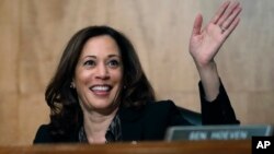 FILE - Sen. Kamala Harris, D-Calif., waves to another member of the committee during a hearing on Capitol Hil in Washington, Oct. 3, 2018. 