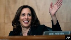 FILE - Sen. Kamala Harris, D-Calif., waves to another member of the committee during a hearing on Capitol Hil in Washington, Oct. 3, 2018. 