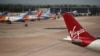 Virgin Atlantic, TUI, and Jet2 aircraft stand near departure gates at Manchester Airport in Manchester, northern England on May 11, 2020, 