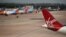 Virgin Atlantic, TUI, and Jet2 aircraft stand near departure gates at Manchester Airport in Manchester, northern England on May 11, 2020, 