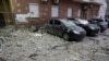 Damaged cars are parked in the yard amid debris after a Russian drone hit a multistory apartment house in Kyiv, Ukraine, Jan. 10, 2025. 