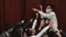 FILE - In this May 8, 2020, photo, pro-democracy lawmaker Eddie Chu Hoi-dick, top center, shouts at security trying to restrain him at a Legislative Council meeting in Hong Kong.