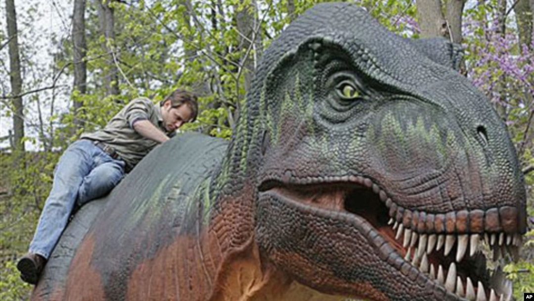 Patrick Cupp puts the finishing touches on a robotic model of a Tyrannosaurus rex at the Cleveland Metroparks Zoo in Cleveland, April 2010.