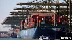 FILE - Container ships are berthed at PSA's Pasir Panjang Terminal in Singapore July 15, 2019. 