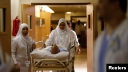 Nurses wheel a patient in the emergency department at Al-Noor Specialist Hospital in Mecca, Saudi Arabia, Sept. 30, 2014.