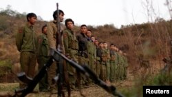 FILE - Rebel soldiers of Myanmar National Democratic Alliance Army (MNDAA) gather at a military base in Kokang region, March 11, 2015