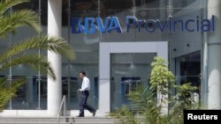 A man walks outside a branch of BBVA Provincial bank in Caracas, Venezuela, April 6, 2018. 