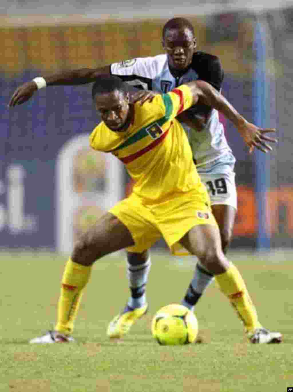 Mali's Seydou Keita (12) plays against Botswana's Mogakolondi Ngele during their final African Cup of Nations Group D soccer match at the Stade De L'Amitie Stadium in Libreville February 1, 2012.