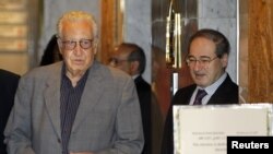 Syria's Deputy Foreign Minister Faisal Mekdad (R) welcomes U.N.-Arab League peace envoy for Syria Lakhdar Brahimi at a hotel in Damascus, October 19, 2012. 