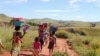 Women and their children walk to the river in the locust infested area in the Vakinankaratra region of central Madagascar, March 30, 2013.