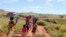 Women and their children walk to the river in the locust infested area in the Vakinankaratra region of central Madagascar, March 30, 2013.