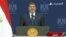 An image taken from Egyptian state TV shows Egyptian President Mohamed Morsi standing on the podium ahead of his televised address to the nation on his first year in power, in Cairo on June 26, 2013. 