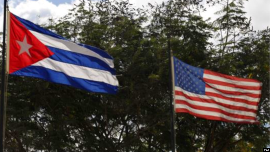FILE - The national flags of Cuba and the United States.