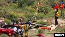 Members of a rescue team work at a site where three bodies were found in the state of Baja California, where one American and two Australian tourists were reported missing, in La Bocana, Mexico, May 3, 2024.