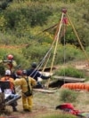 Members of a rescue team work at a site where three bodies were found in the state of Baja California, where one American and two Australian tourists were reported missing, in La Bocana, Mexico, May 3, 2024.